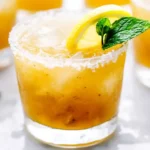 Refreshing Arnold Palmer Spiked Cocktail With Lemon And Mint Garnish.